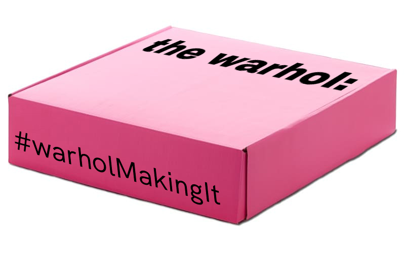 A pink box with the words The Warhol written on the top and #warholMakingIt written on the side in black ink