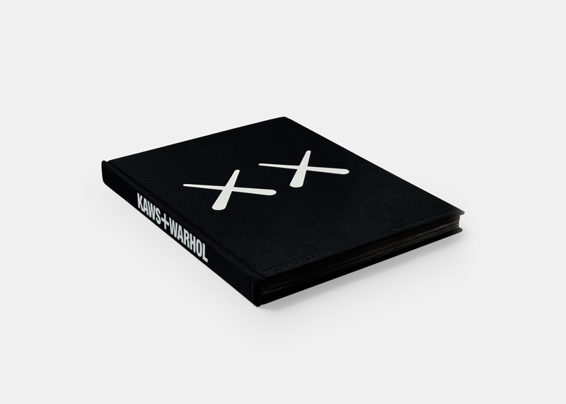 The cover of a black hard cover book. On the cover is two white Xs in a row in the middle of the cover. The spin of the book reads KAWS+WARHOL.