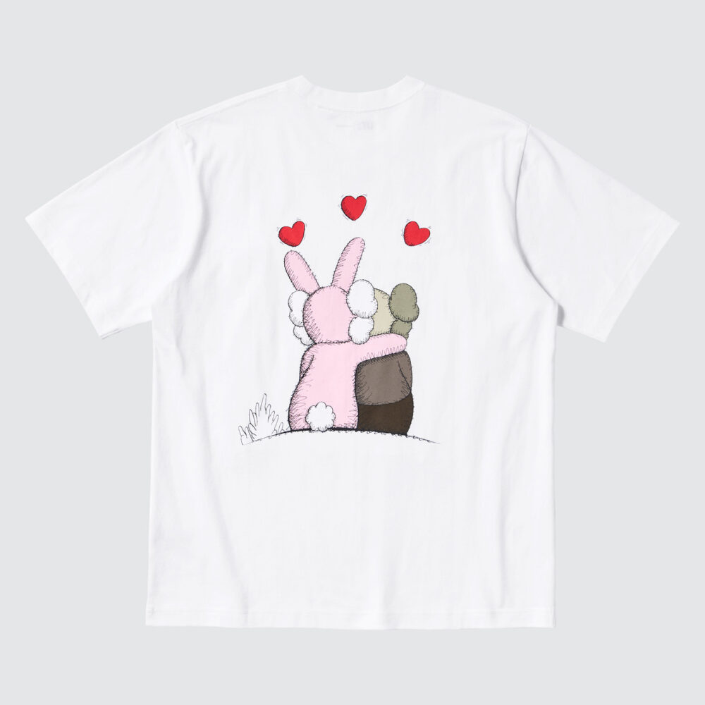 White Tee back. Back of pink bunny with it's arm over KAWS Mascot's shoulder. Facing away from viewer