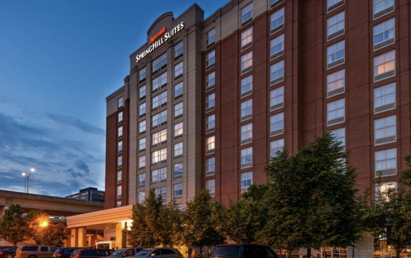 The exterior of a large hotel during dusk.