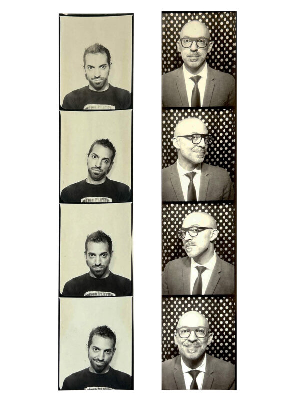 Two photobooth photograph strips, each consisting of 4 black and white photographs. The right photograph strip is a man sits in front of a white background and wears a dark shirt. The left strip is of a man wearing glasses and a suit with a tie in front of a polka dot background.